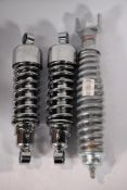 Two unbranded 10.5in motorcycle shock absorbers and an as new Carbone 6033.002/5A motorcycle shock a