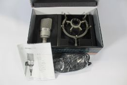 A Neumann TLM 102 Studio Set Microphone + Shock Mount (Nickel) (Possibly pre-owned).