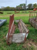 Wooden feed barrier with trough