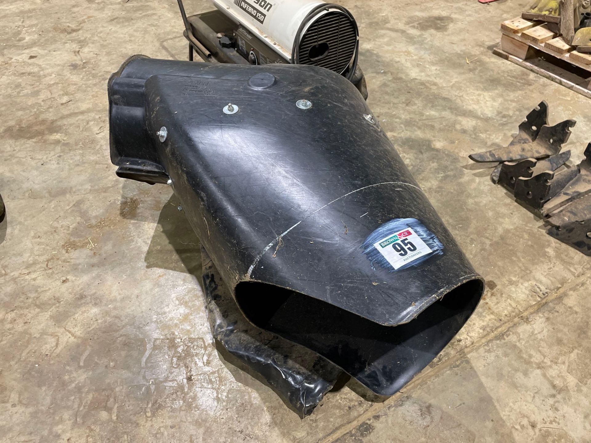 New Holland combine auger chute with extended sock