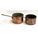 Two 19th century beaten copper saucepans with brass handles, 26cmD and 23.5cmD
