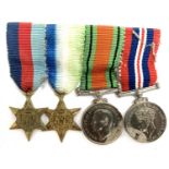A collection of four miniature medals to include World War II service medal, The Defence Medal,