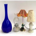 A tall blue glass vase with lobed base, 50cmH, together with an oil lamp and two table lamps