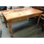 A pine kitchen table on turned legs, 151x89x76cmH