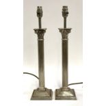 A pair of white metal table lamps in the form of Corinthian columns, 38.5cmH to top of fitting; with