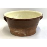 A 19th century terracotta glazed dairy bowl, 49cmD, 23cmH