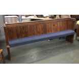 A pine church pew, with loose cushion, one end inscribed 44, 217cmL