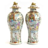 A pair of Chinese famille rose baluster vases with covers, painted with court scenes (af), 34cmH