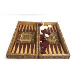 A parquetry and marquetry chess and backgammon board, with pieces, 50cmW