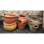 Two terracotta strawberry planters together with a further four terracotta plant pots