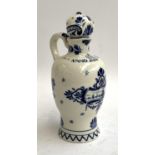 An early 20th century Delft lidded jug, painted with windmill scene with script 'Anno 1575', date