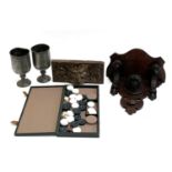 A carved wall bracket with leopard's head, a carved drawer front, a draughts set and 2 pewter
