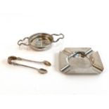 A silver tea strainer, Birmingham 1917; a Mappin & Webb silver ashtray; and a pair of silver sugar