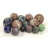A quantity of decorative ceramic balls, to include four by India Jane decorated with red pastoral