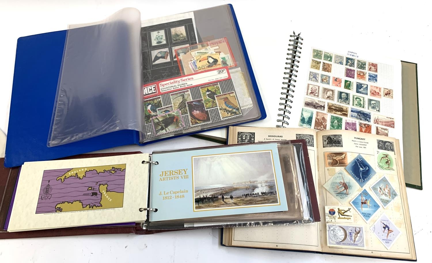 Two stamp albums containing British and World stamps, together with an album of Jersey