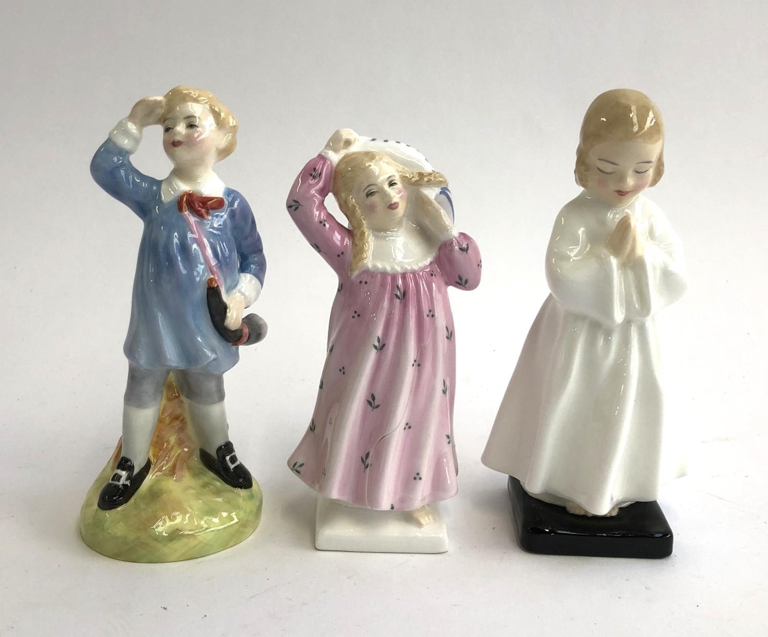 Three Royal Doulton figurines, 'Little Boy Blue', 'Pillow Fight' `(af) and 'Bed time', the tallest