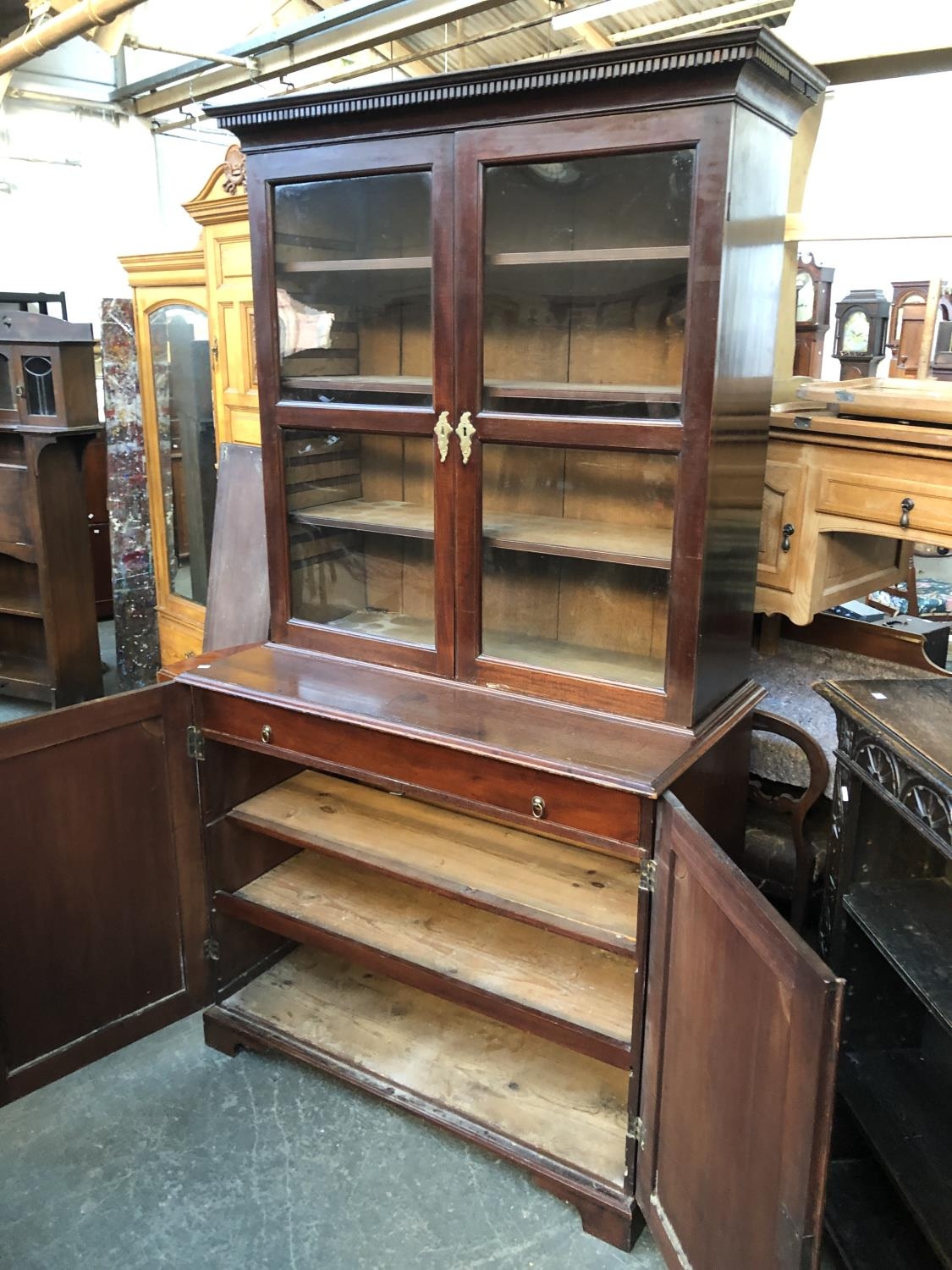 A George III mahogany library bookcase, dentil cornice over two glazed doors, opening to three - Image 2 of 2