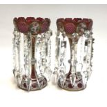 A pair of cranberry and cut glass table lustres, with painted floral panels (one cut glass 'gem'
