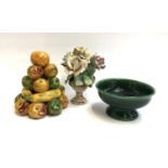 A majolica stack of fruit, 21cmH; together with a Continental ceramic bouquet of roses, and a