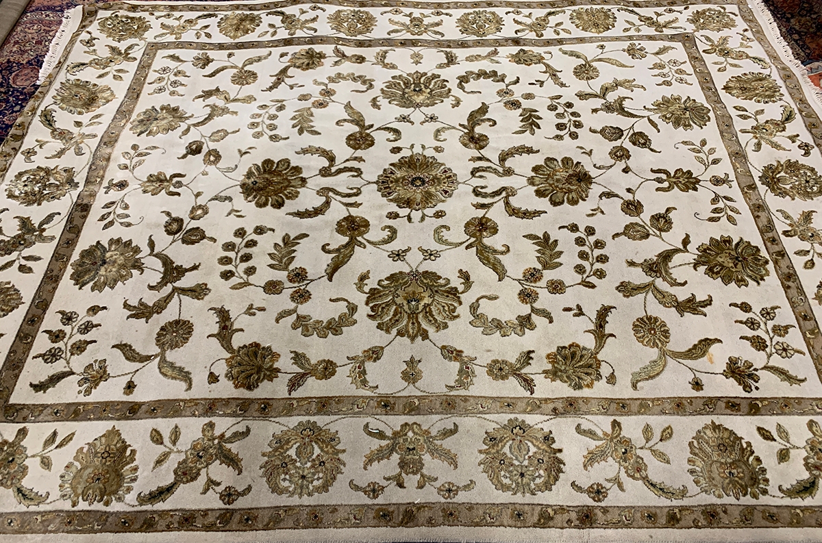 A large cream ground floral wool rug, 315x240cm