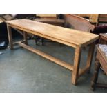 A narrow pine kitchen table, on solid legs and H stretcher, 214x60x74cmH