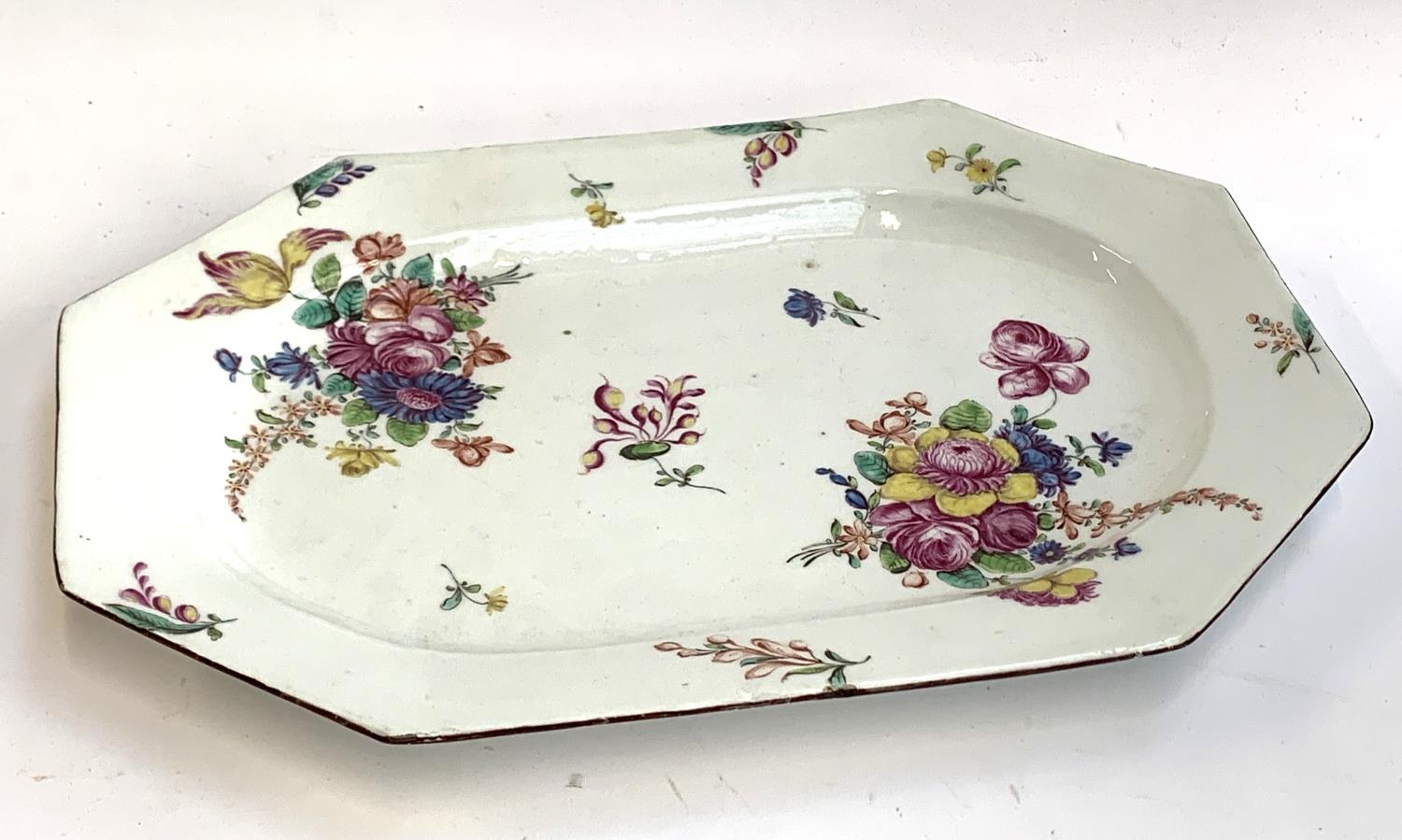 A bow shaped octagonal serving dish or tureen stand, circa 1765, painted with flowers in the Meissen