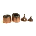 Two Victorian copper jelly moulds, one marked A & N, CSL, together with two copper funnels