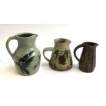 Three Studio Pottery jugs with makers’ marks, the tallest 20cm high