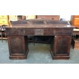 A large Victorian mahogany pedestal sideboard, three drawers, the central drawer with carved