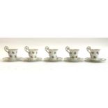 A set of five continental hand painted porcelain coffee cups, 8cmH, and six saucers, 10.5cmD