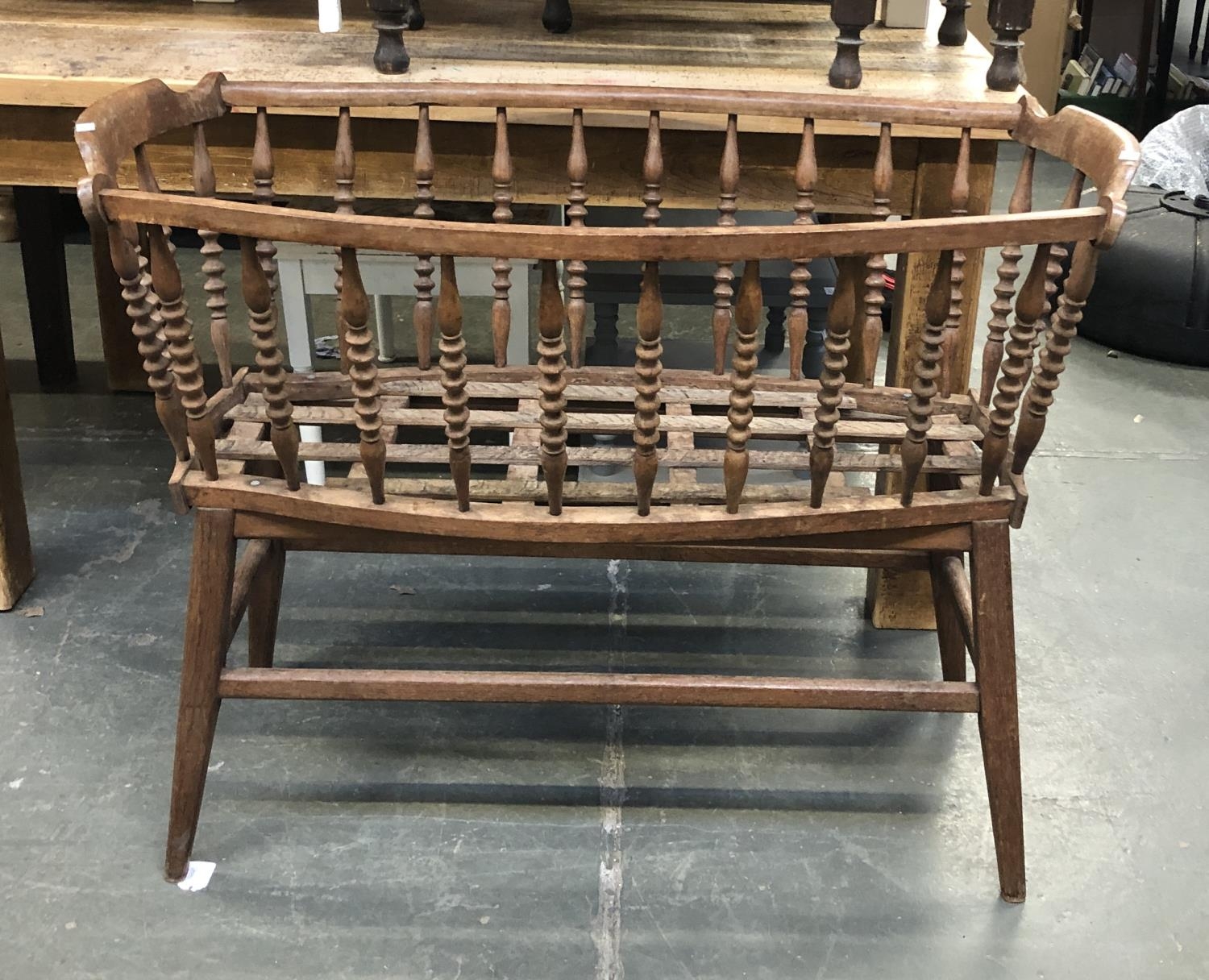 A spindle turned beechwood cradle, on stand, 107cmW