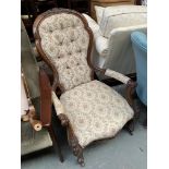 A Victorian carved walnut button back bedroom chair on casters