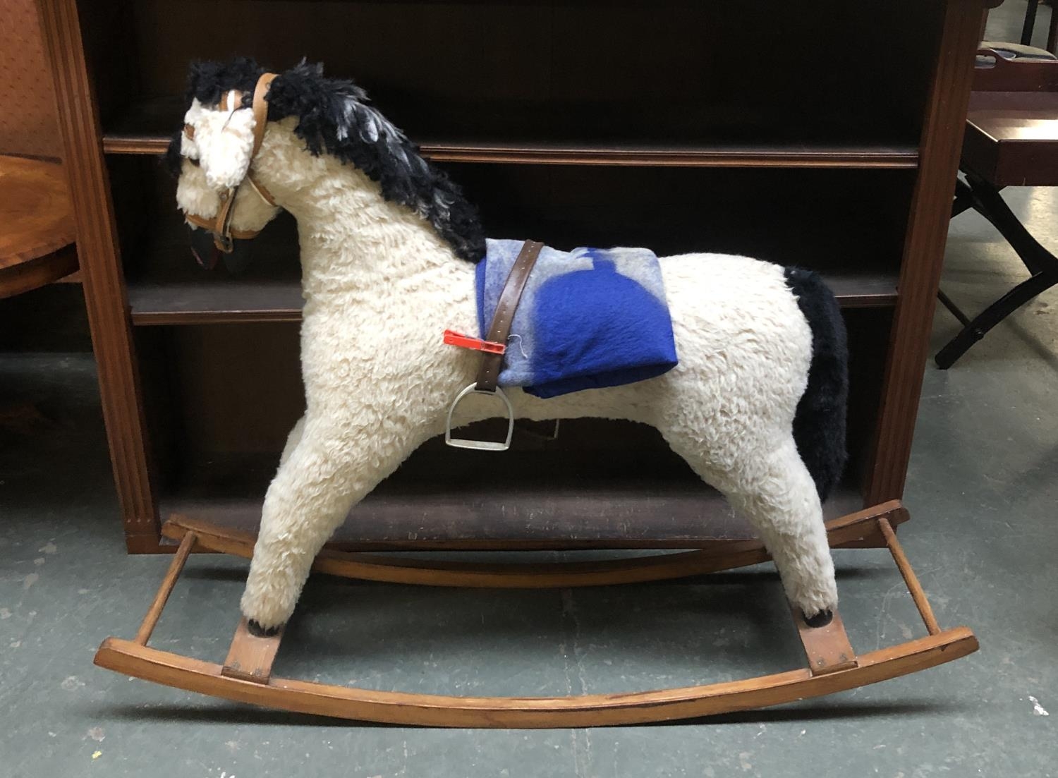 A vintage upholstered rocking horse, 106cmL