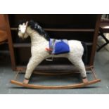 A vintage upholstered rocking horse, 106cmL