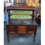 A mahogany wash stand, with tiled upstand and marble top, with single pot cupboard, on turned legs