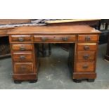 A early 20th century pedestal desk, wit the traditional arrangement of nine drawers, 120x58x74cmH