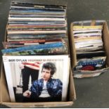 A quantity of vinyl LPs and 7 inch singles to include Bob Dylan, Led Zeppelin, The Beatles, Simon