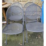 A set of four folding metal garden chairs