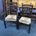 Two rush seated ash ladder back chairs, one with arms