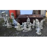 A quantity of composite stone garden gnomes and other figures