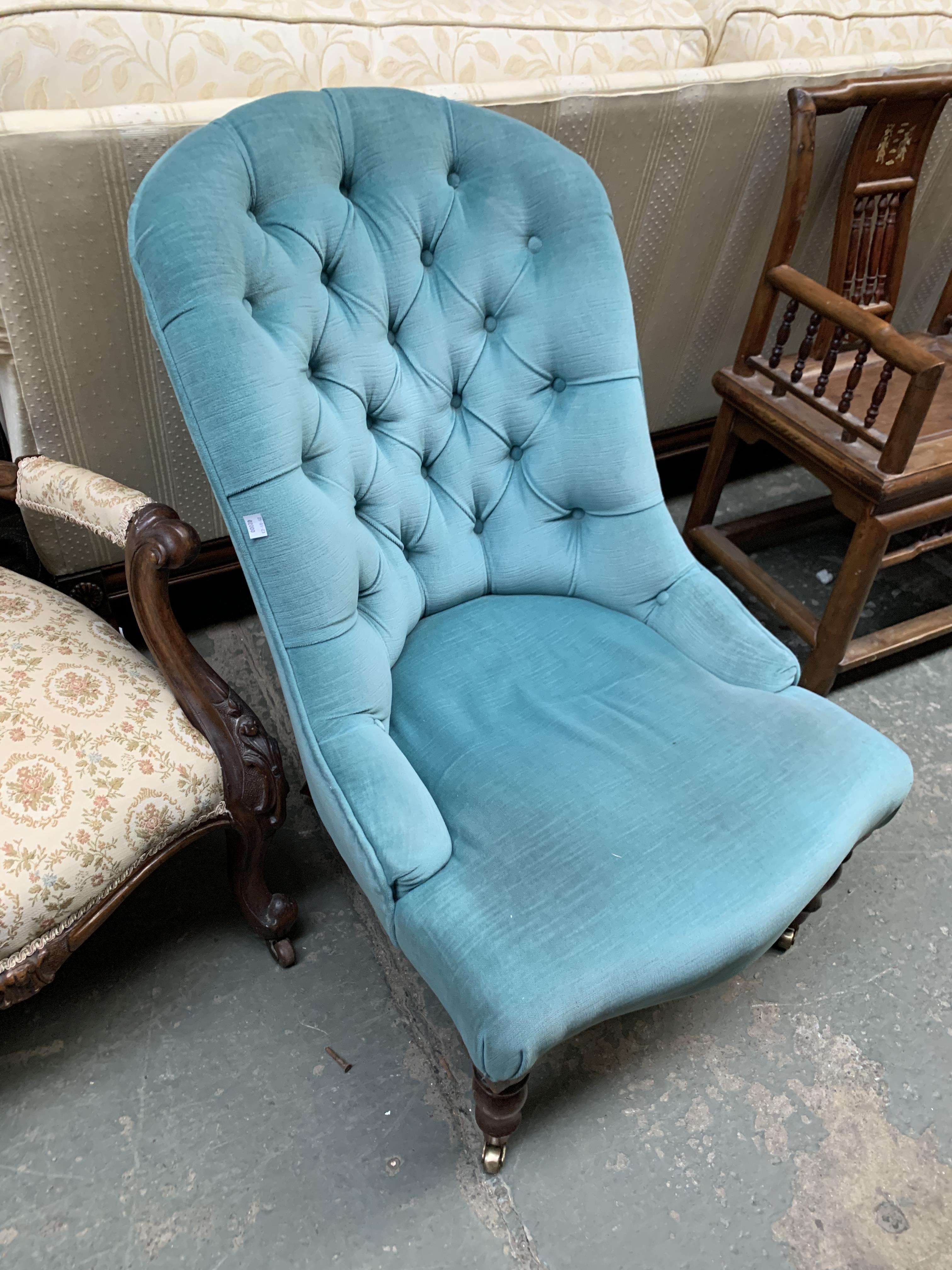 A 20th century buttonback bedroom chair, upholstered in turquoise fabric, on turned legs and brass