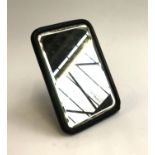 A small ebonised looking glass, rectangular bevelled plate, white metal 'A' to reverse, 17.5x12cm