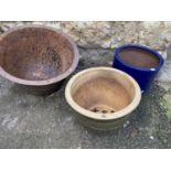 Two glazed terracotta planters, together with a large iron copper