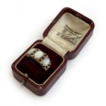 A heavy 9ct gold ring set with opals and garnets, size M 1/2, approx. 6.3g, in an antique ring box