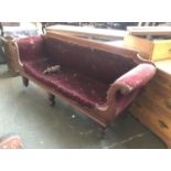 A Victorian sofa with scrolling carved mahogany frame, one leg af, 205cmW