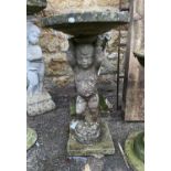 A composite stone bird bath of a cherub, 80cmH