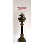 A brass oil lamp with glass chimney and shade, Corinthian capital on square set base, 80cmH to top