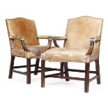 A pair of George III style mahogany and leather upholstered Gainsborough armchairs, 73cm wide, the
