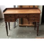 A 19th century mahogany dressing table, three quarter gallery, five drawers surrounding kneehole, on