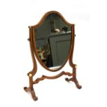 A mahogany shield shaped dressing mirror with ivorine roundels, 52cmH